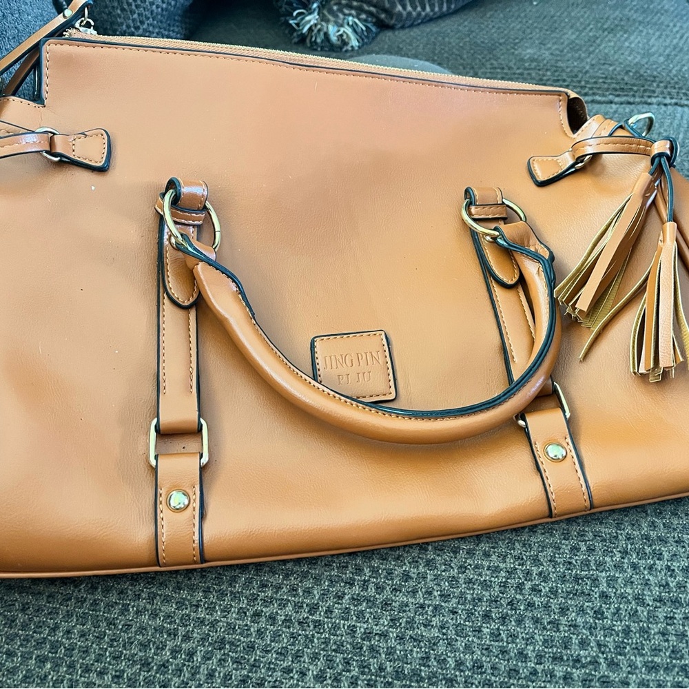 Burnt Orange purse with side tassels.